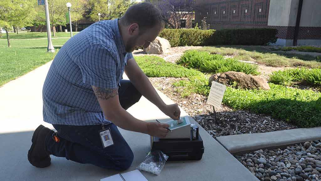 Professional testing the air using a sampling pump.