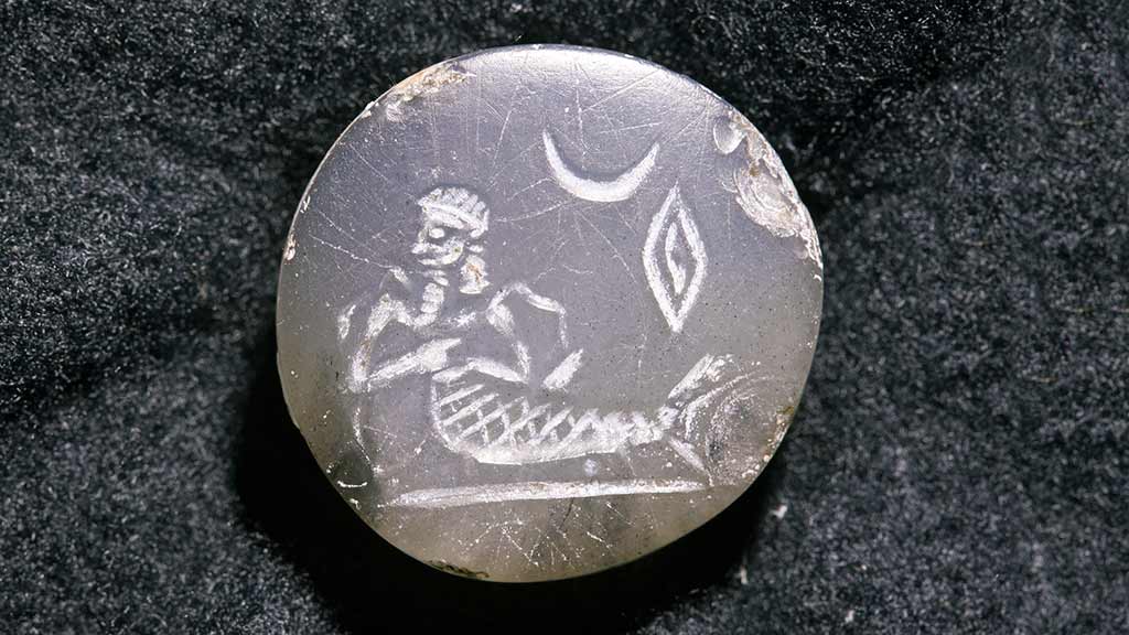 engraved circular seal with fish-man