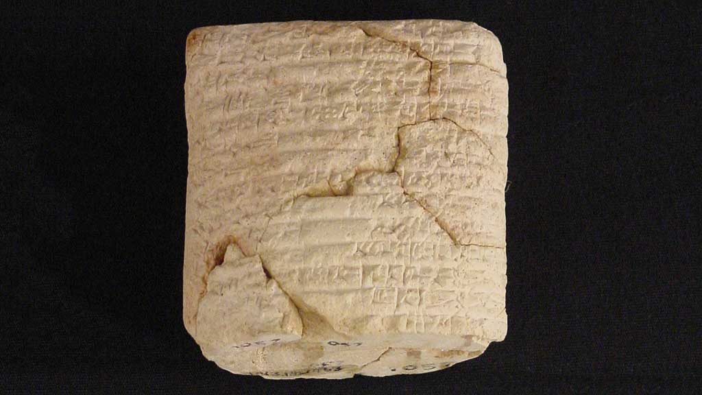 cream-colored cracked square stone with cuneiform